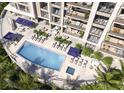 Luxury condo with a stylish swimming pool with lounge chairs and views from the balconies at 325 Golden Gate Pt # 1004, Sarasota, FL 34236
