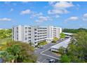 An aerial view showing the condo building, parking lot, and surrounding landscaping at 3790 Pinebrook Cir # 408, Bradenton, FL 34209