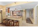 Charming kitchen features a breakfast bar with seating, granite countertops, and stainless steel appliances at 3790 Pinebrook Cir # 408, Bradenton, FL 34209