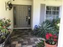 Inviting front entrance with a decorative door, sidelights, and lush plantings, showcasing a warm and welcoming entryway at 405 Park N Blvd, Venice, FL 34285