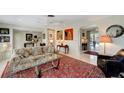 Bright living room featuring stylish furnishings, unique artwork, and an open layout perfect for relaxation and entertaining at 405 Park N Blvd, Venice, FL 34285