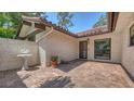 Charming courtyard features brick paving, a fountain, and stucco walls for a private outdoor space at 5458 Golf Pointe Dr, Sarasota, FL 34243