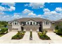 Aerial view of townhomes with attached garages, manicured lawns, and beautiful landscaping at 5543 Pleasantview Ct, Bradenton, FL 34211