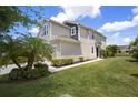 Charming two-story home with a well-manicured lawn and lush landscaping at 5543 Pleasantview Ct, Bradenton, FL 34211