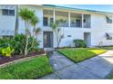 Well-maintained condo building featuring lush landscaping and a welcoming entrance at 5663 Midnight Pass Rd # 407, Sarasota, FL 34242