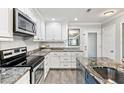 This kitchen features ample counter space, white cabinetry, and updated appliances at 5663 Midnight Pass Rd # 407, Sarasota, FL 34242