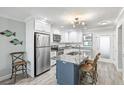 Bright kitchen featuring stainless steel appliances, granite counters, and a center island at 5663 Midnight Pass Rd # 407, Sarasota, FL 34242