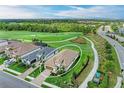 Expansive aerial shot of a home nestled in a golf community with lush greenery and serene surroundings at 5810 Brandon Run, Bradenton, FL 34211