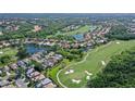Stunning aerial view of property on a golf course with lush landscaping and serene lake views at 6642 Oakland Hills Dr, Lakewood Ranch, FL 34202