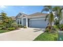 Charming single-story home featuring a well-manicured lawn and a two-car garage at 8110 Trimbelle Ter, Parrish, FL 34219