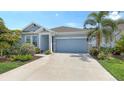 Charming single-story home featuring a well-manicured lawn and a two-car garage at 8110 Trimbelle Ter, Parrish, FL 34219