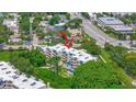 Aerial view of the condominium complex showcasing its architecture, landscaping, and location at 825 S Osprey Ave # 302, Sarasota, FL 34236