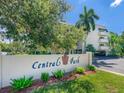 Entrance to Central Park with lush landscaping, mature trees, and manicured lawn at 825 S Osprey Ave # 302, Sarasota, FL 34236