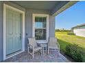 Inviting front porch with seating area perfect for enjoying warm days at 8313 Ocean Tides Cv, Parrish, FL 34219