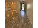 Open-concept living area with wood-look flooring, providing a spacious and airy atmosphere at 940 Byron Ct # 17C, Sarasota, FL 34243