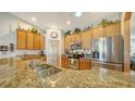 Kitchen with stainless steel appliances, granite countertops, and bright lighting at 5356 Mang Pl # 1404, Sarasota, FL 34238