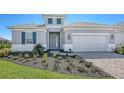 Charming single-Gathering home featuring a paved driveway, two-car garage, and well-manicured lawn at 10027 Cross River Trl, Parrish, FL 34219