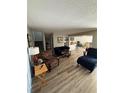 Spacious living room featuring hardwood floors and a view of the staircase to the second floor at 1147 Longfellow Rd # 157C, Sarasota, FL 34243