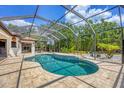 Large screened in pool with brick pavers and beautiful landscaping at 11551 30Th E Cv, Parrish, FL 34219