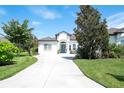 Beautifully landscaped home features a welcoming entrance with a lovely garden and a well-maintained lawn at 13130 50Th E Ct, Parrish, FL 34219