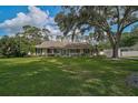 Inviting single-story home with a lush lawn and a spacious front yard shaded by mature trees at 13612 11Th E Ter, Bradenton, FL 34212