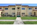 The condo building has yellow walls, a red tile roof, and a well-manicured lawn at 1431 57Th W St # 1431, Bradenton, FL 34209