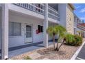 Condo building exterior showcasing unit 135, front entrance, and tropical landscaping at 1535 Pleasant Rd # H5, Bradenton, FL 34207
