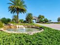 Well-manicured landscape with water feature welcomes you to the luxurious community at 17704 Gawthrop Dr # 102, Bradenton, FL 34211