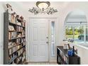 Bright foyer featuring a view of the window and a door to the living area at 18033 Edgewater Dr, Port Charlotte, FL 33948