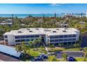 Lovely low-rise condo building featuring coastal views, mature palms and well-maintained landscaping at 225 Hourglass Way # 306, Sarasota, FL 34242