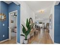 Bright hallway with wood floors that leads into the main living areas, complemented by modern lighting at 3443 74Th Avenue E Cir, Sarasota, FL 34243