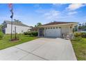 Inviting single-story home with an attached two-car garage and well-manicured front lawn at 3459 Lotus Rd, North Port, FL 34291