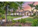 Gorgeous home with lush landscaping, healthy trees, and a long, paved driveway at 3519 Founders Club Dr, Sarasota, FL 34240