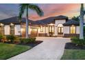Beautiful home with manicured lawn, paver driveway, and an attached two-car garage at 3519 Founders Club Dr, Sarasota, FL 34240