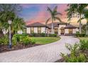 Lovely home featuring an immaculate lawn, paved driveway, and well-maintained landscaping at 3519 Founders Club Dr, Sarasota, FL 34240