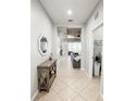 Bright hallway with ceramic tile floors leading to the living area and laundry room at 4578 Cedar Brush Ter, Sarasota, FL 34243