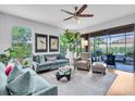 Bright and airy living room with stylish furnishings, hardwood floors, and view of screened lanai at 4704 Stafford Ct, Palmetto, FL 34221