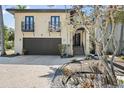 Elegant home with a two-car garage, charming balconies, and attractive landscaping at 4964 Commonwealth Dr, Sarasota, FL 34242