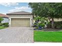 Well-maintained home with a paved driveway, two-car garage, and manicured landscaping at 5019 Serata Dr, Lakewood Ranch, FL 34211