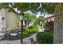Tranquil garden featuring lush landscaping and a charming white arbor at 5019 Serata Dr, Lakewood Ranch, FL 34211