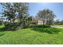 A charming house surrounded by vibrant greenery, featuring a manicured lawn and a well-maintained driveway at 5032 Timber Chase Way, Sarasota, FL 34238