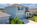 Stylish two-story home with a side entry garage, well-kept landscaping and a covered front porch at 5715 Woodland Sage Dr, Sarasota, FL 34238