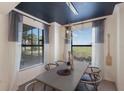 Inviting dining room with modern lighting fixture, neutral decor, and large windows at 5720 Palmer Cir # 103, Bradenton, FL 34211