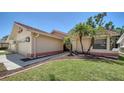 Inviting home exterior featuring a red tile roof, lush green lawn, and meticulously maintained landscaping at 6128 Nicole Dr, Sarasota, FL 34243