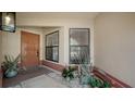 Welcoming front porch with neutral tones, potted plants, and a secure front door for a cozy entrance at 6128 Nicole Dr, Sarasota, FL 34243