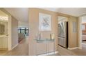 Inviting condo entryway with wood floors and an open view to the living area at 6267 Midnight Pass Rd # 306, Sarasota, FL 34242