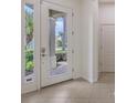 Bright entryway features a white door with glass panels and tile flooring at 7158 Westhill Ct, Lakewood Ranch, FL 34202