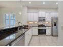 Modern kitchen with white cabinetry, stainless steel appliances, and granite countertops for a sleek and stylish design at 7158 Westhill Ct, Lakewood Ranch, FL 34202