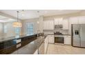 Modern kitchen with stainless steel appliances, granite countertops, and pendant lighting at 7158 Westhill Ct, Lakewood Ranch, FL 34202