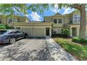 Inviting townhome featuring a two-car garage, neutral exterior, and well-maintained landscaping at 7576 Plantation Cir, Bradenton, FL 34201